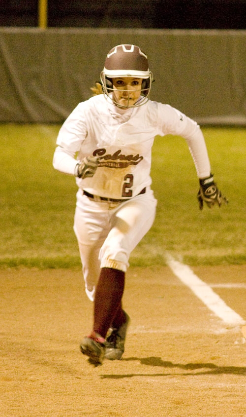 Katlyn Strauss eyes home plate as she leaves third base.