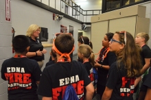 Jailer Tara Timberlake shows Jackson County Fire Camp attendees around the jail.