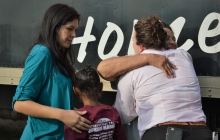 Thelma Williams and Margo Hosey hug Ashley Furniture Homestore representatives as they drop off her new furniture.