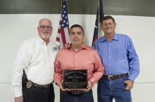 Edna Police Chief Clinton Wooldridge, Officer Luis Chavez, and 100 Club President Gary Kacer