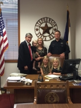 Deputy Bryan Martin with his family and Representative Phil Stephenson