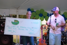 Rachel and Cody Revel reveal to a crowd that the benefit raised $44,000 for Texas Children's Hospital, in memory of their son, Wyatt Ray Revel.